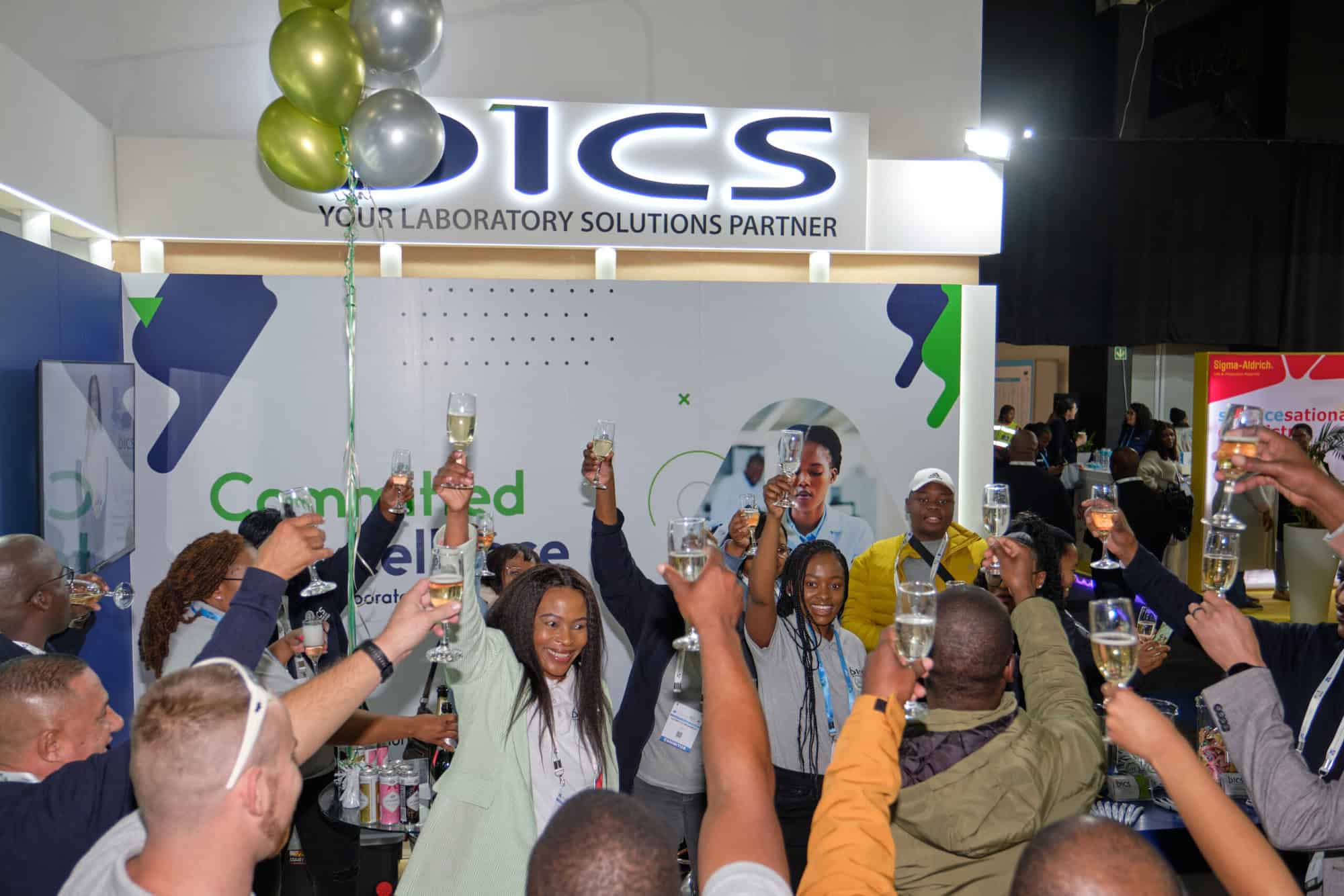 Lomo and fellow attendees raising a glass in celebration