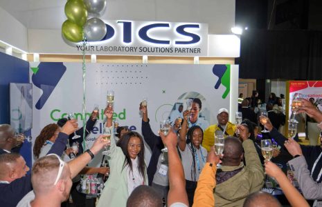 Lomo and fellow attendees raising a glass in celebration